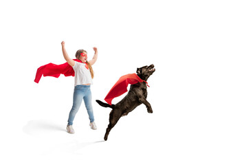 Child pretending to be a superhero with her super dog isolated on white studio background