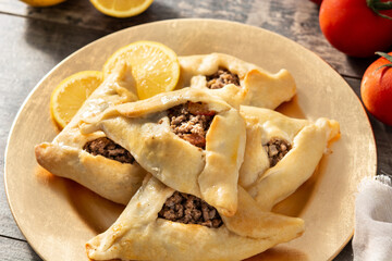 Traditional middle eastern fatayer on wooden table