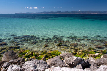 Crystal clear water, rocks and white sand for background
