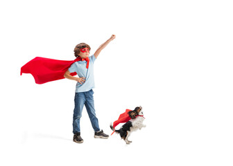 Child pretending to be a superhero with his super dog isolated on white studio background © master1305
