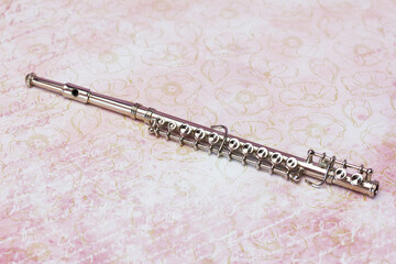 music woodwind instrument - Brass silver metal flute on a beautiful   flowers background