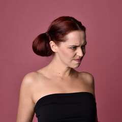 close up portrait of red haired women with different facial expressions on a pink studio background.