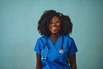 woman doctor smiling with stethoscope looking front - obrazy, fototapety, plakaty