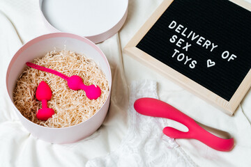 light background with different sex toys. Online shopping, shopping, delivery, the concept of Stay...