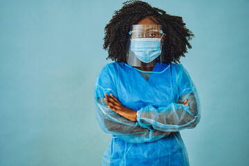 Nurse practitioner doctor with personal protective equipment face shield goggles crossed arms, coronavirus - obrazy, fototapety, plakaty