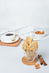 Italian cranberry almond biscotti and cup of coffee on background. Selective focus. Vertical orientation