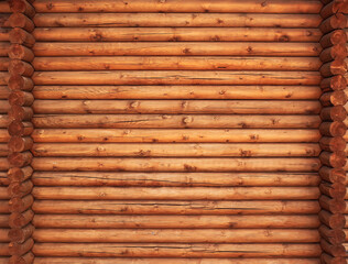A wall of the pine round timbers. Wooden texture.