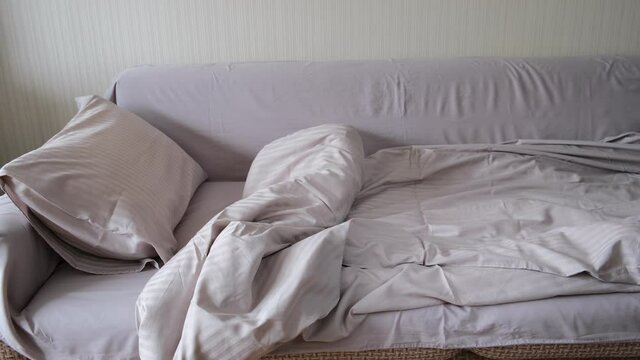 bed with pillow and blanket, gray linens