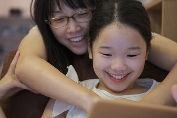 Smile mother and daughter in their home