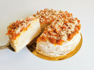 Homemade cake with dried apricots on a white background. Honey cake. Isolated on white. Sweet and delicious dessert for tea or coffee. Side view.