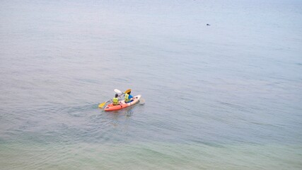Aerial view of couple kayaking in the sea.