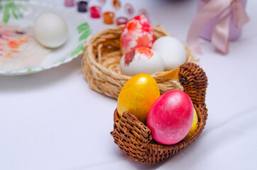 Basket nest with painted chicken eggs. Religious Orthodox holiday Easter