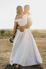 Fototapeta na wymiar Portrait of a bride and groom in a sunset light