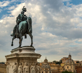 Fototapeta na wymiar Rome. Bronze statue of a rider on a horse against the background of the city and the blue summer sky