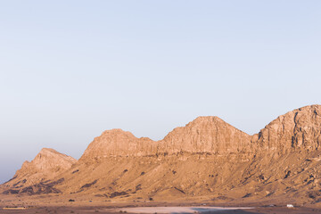 Fototapeta na wymiar Jebel al Fayah (Al Faya) mountain range in Mleiha, Sharjah, United Arab Emirates, rocky and barren mountain ridge in the desert.