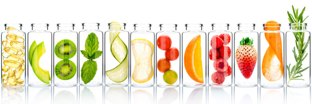 Homemade Skin Care With Fruits Ingredients Avocado ,orange ,blueberry ,pomegranate ,kiwi ,lemon Slice ,cucumber ,tamarind ,strawberry And Raspberry In Glass Bottles Isolated On White Background.