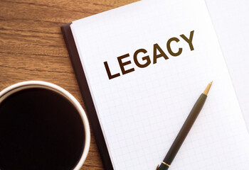 LEGACY - text on notepad on wooden desk.