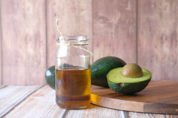 Almond oil in bottle on wooden background. top down