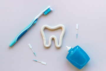 Teeth care and dental hygiene. Toothbrush with tube of toothpaste, flat lay