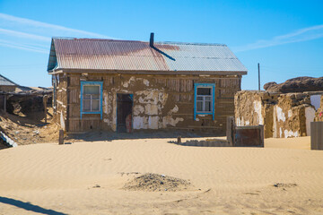 ecological disaster in Central Asia. Sandy desert and a village on the shores of the dry Aral Sea.