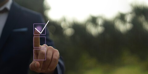 Checklist concept, Businessman checking mark on the check boxes with marker red