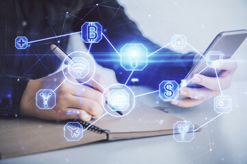 Double exposure of social network sketch hologram and woman holding and using a mobile device.