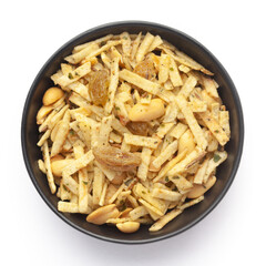 Close-Up of Aloo Mixture in a black Ceramic bowl made with potatoes, peanuts, raisins. Indian spicy snacks (Namkeen), Top View