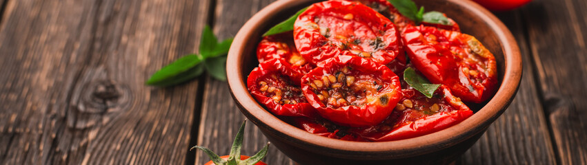 Sun-dried tomatoes in bowl seasoned with olive oil and spices banner