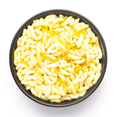 Close-Up of Crunchy Lemon Bhel in a black ceramic bowl made with Puffed Rice small besan sev. Indian spicy snacks (Namkeen), Top View