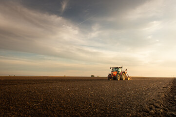 Naklejka premium Farmer with tractor seeding