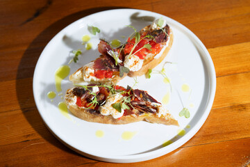 bruschetta with basturma, cottage cheese and pepper with herbs