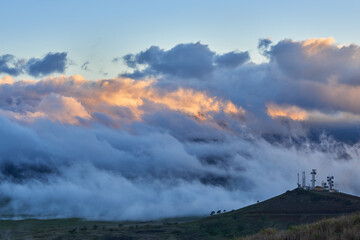 Landscape with clouds under the slopes of Mauna Kea in Hawaii at sunset.