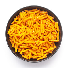 Close up of Nimbu masala besan sev Indian namkeen (snacks) on a ceramic black bowl. Top view