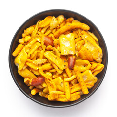 Close up of salted Gujrati Mix Indian namkeen (snacks) on a ceramic black bowl. Top view