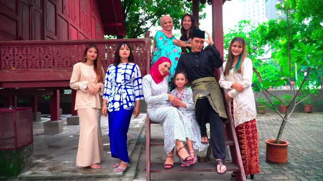 A group of malay people at the wooden house celebrating Hari Raya festive