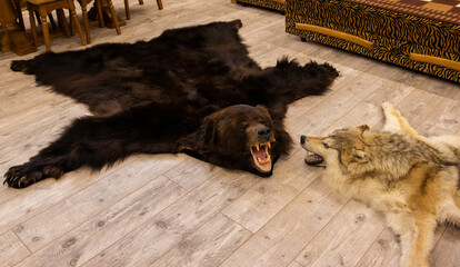 bear and wolf skins on the floor in the hunter's room