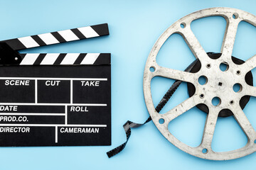 Movie film reel with clapperboard. Cinema concept
