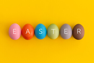 Colored eggs on a white background. Minimal easter concept.	
