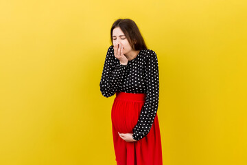 Pregnant woman suffering from toxicosis. Toxicosis Of Pregnancy. Pregnant Lady Feeling Sick Having Nausea Standing On Colored isolated Background. Free Space