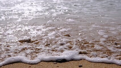 Fototapeta na wymiar O mar envolvendo lentamente a areia