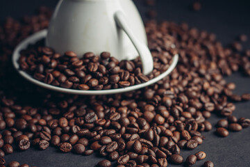 coffee grain on inverted mug and saucer on gray Arabica table