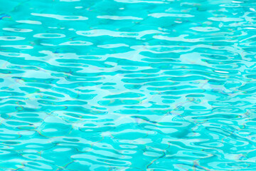 Ripple Water in swimming pool with blue tile floor background