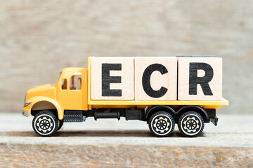 Toy truck hold alphabet letter block in word ECR (Abbreviation of Efficient Consumer Response, Early Career Researcher, Engine control room) on wood background