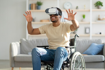 Handicapped black man in wheelchair exploring augmented reality in VR headset at home. Futuristic...