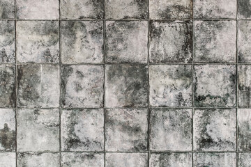 Dark gray square ceramic floor tiles with abstract pattern, mosaic texture background