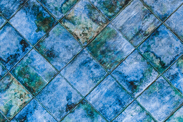 Blue diagonal square ceramic floor tiles with abstract pattern, mosaic texture background