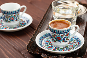 Cup of coffee in oriental style on metal tray
