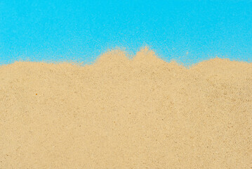 Fototapeta na wymiar Artificial beach made of cardboard and sand. Stylized sea. The concept of rest, sea and vacation.