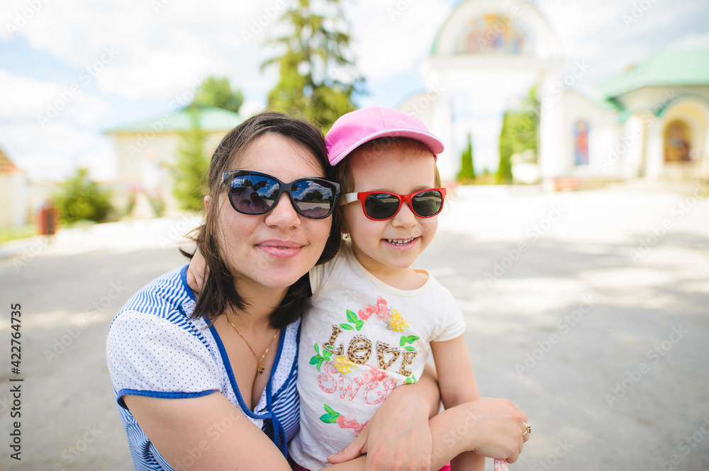 Poster mother and daughter in sunglasses