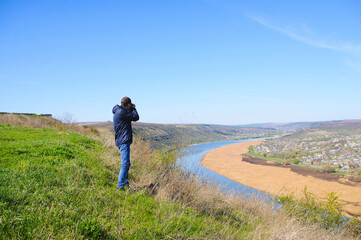 Obraz premium young photographer making landscape pictures
